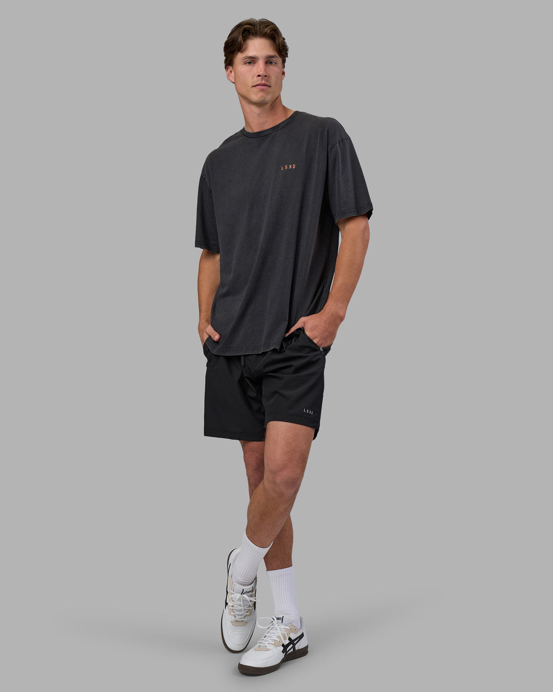 Man wearing Unisex Strike Through FLXCotton Tee Oversize - Black Washed-Cantaloupe | Model:Brandon | Size:L - view 6