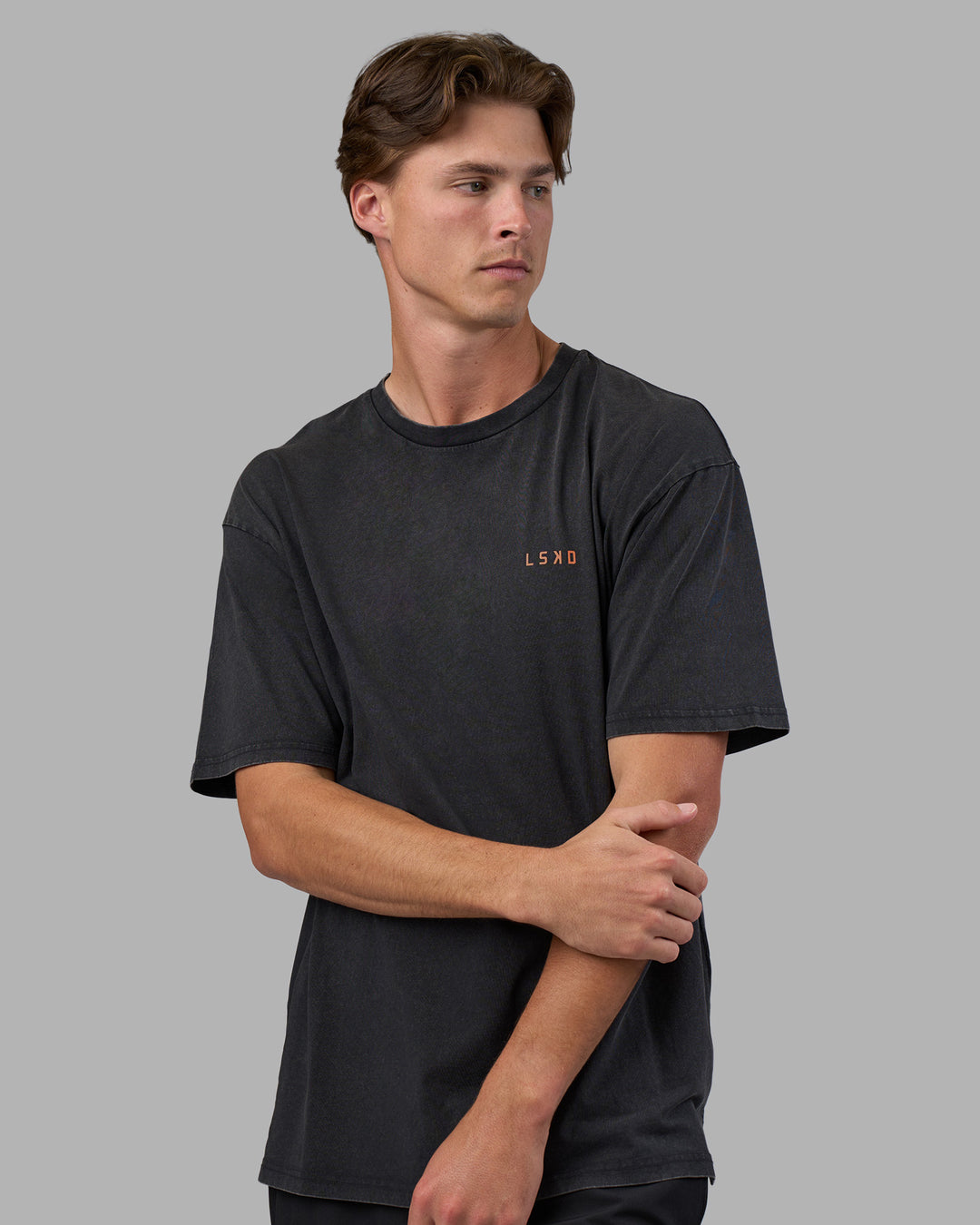 Man wearing Unisex Strike Through FLXCotton Tee Oversize - Black Washed-Cantaloupe | Model:Brandon | Size:L - view 3