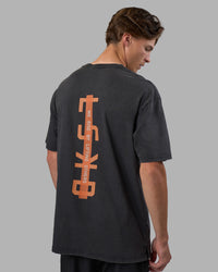 Man wearing Unisex Strike Through FLXCotton Tee Oversize - Black Washed-Cantaloupe | Model:Brandon | Size:L | Thumbnail Index: 1