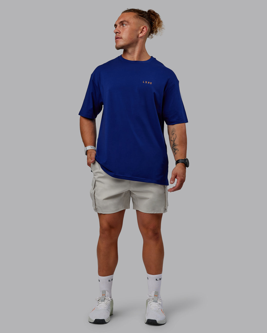 Man wearing Unisex Strike Through FLXCotton Tee Oversize - Midnight Blue-Vibrant Orange - view 11