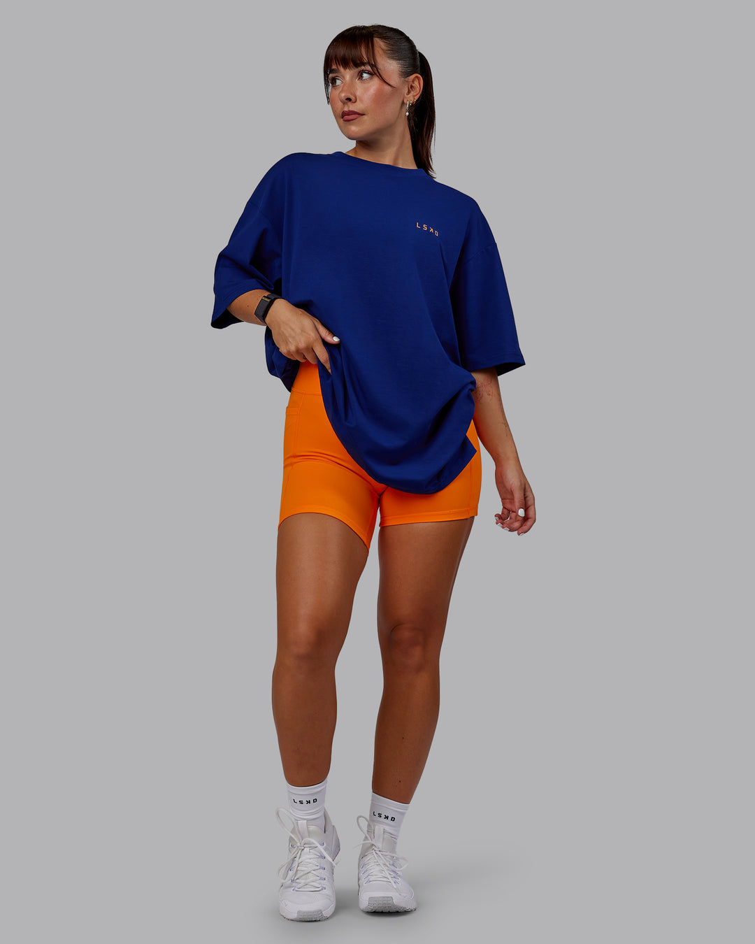 Woman wearing Unisex Strike Through FLXCotton Tee Oversize - Midnight Blue-Vibrant Orange - view 10