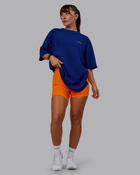 Woman wearing Unisex Strike Through FLXCotton Tee Oversize - Midnight Blue-Vibrant Orange | Thumbnail Index: 9