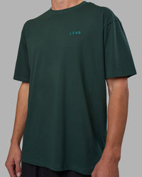 Man wearing Unisex Strike Through FLXCotton Tee Oversize - Vital Green-Alexandrite | Model:Brandon | Size:L | Thumbnail Index: 5
