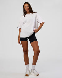 Woman wearing Unisex Strike Through FLXCotton Tee Oversize - White-Warm Apricot | Model:Kirstyn | Size:L | Thumbnail Index: 6