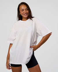 Woman wearing Unisex Strike Through FLXCotton Tee Oversize - White-Warm Apricot | Model:Kirstyn | Size:L | Thumbnail Index: 2