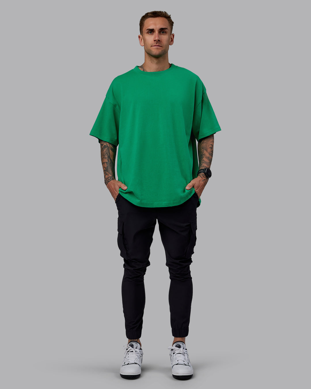 Man wearing Unisex We Rise Heavyweight Tee Oversize - Impact Green-White - view 10