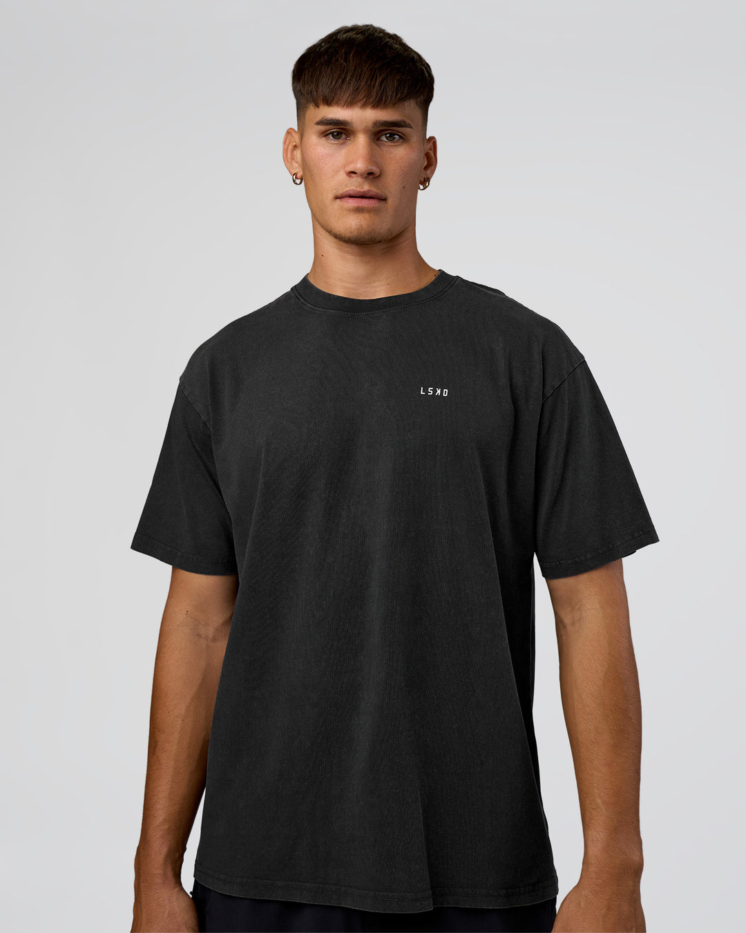 Man wearing We Love This  FLXCotton Oversized Tee - Black Washed-White | Model:Jackson | Size:L - view 2