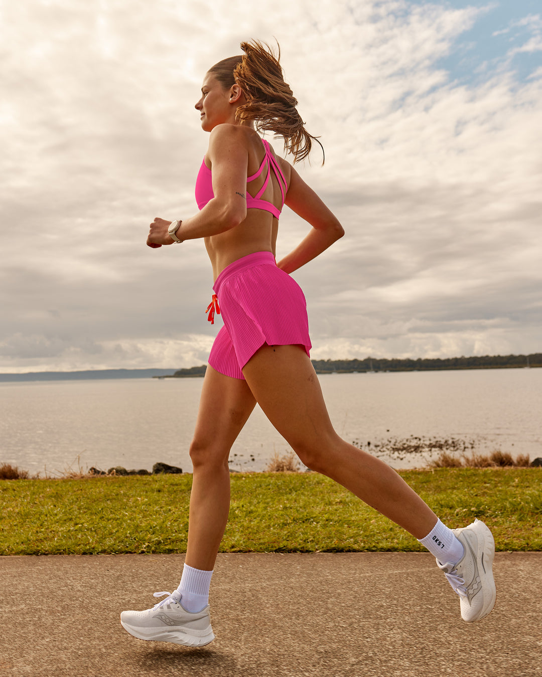 Woman wearing Accelerate 3" Pleated Running Short - Ultra Pink | Model:Phoebe | Size:M - view 4