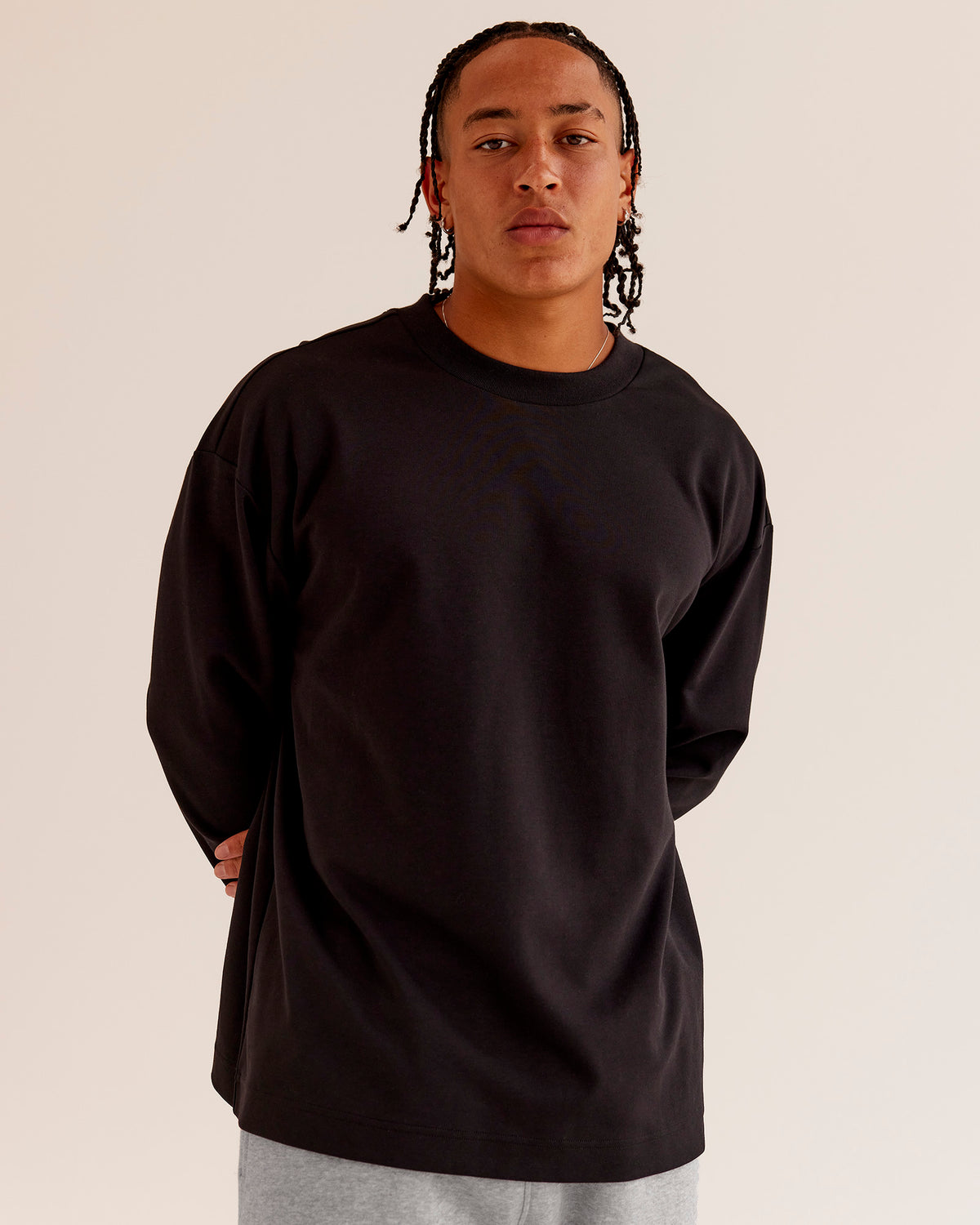 Man wearing AfterDark ZeroCrease Long Sleeve Tee - Black | Model:Malebo | Size:M