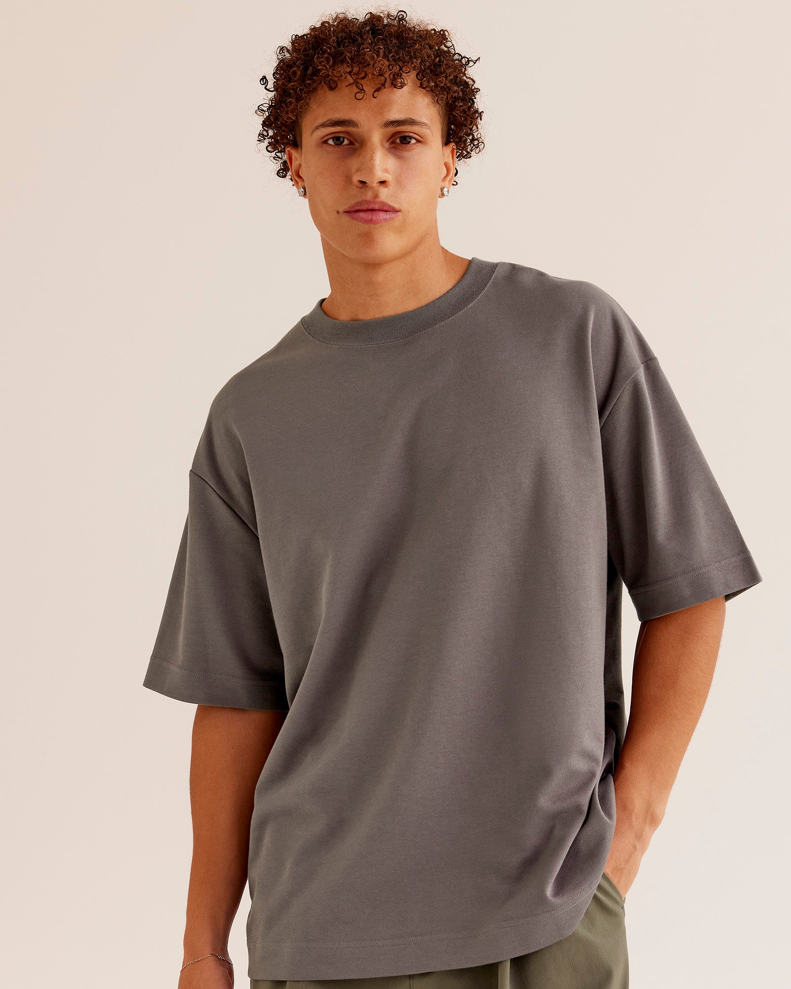 Man wearing AfterDark ZeroCrease Oversized Tee - Duskstone | Model:Leandro | Size:M