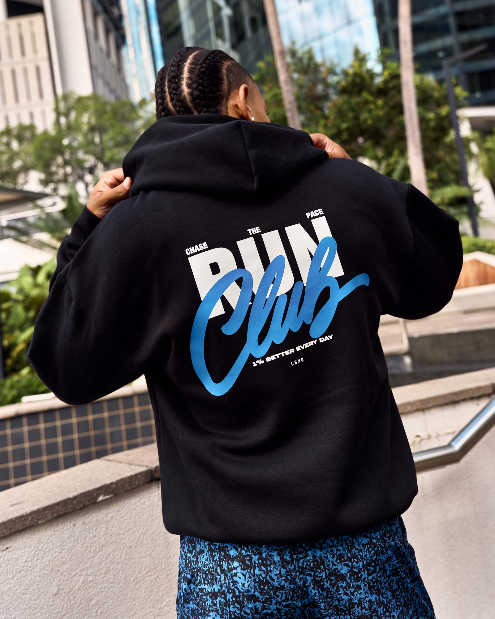 Man wearing Run Club Script Oversized Hoodie - Black-Palace Blue | Model:Malebo | Size:M