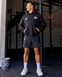 Man wearing Static Grit Unisex Boxy Hoodie - Black-Alloy | Model:Jaiden | Size:M | Thumbnail Index: 2