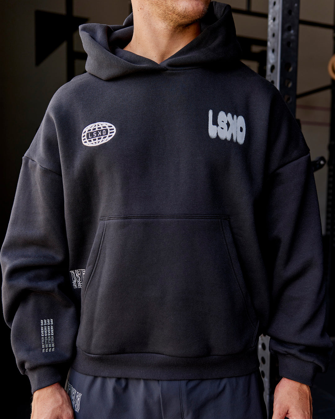 Man wearing Static Grit Unisex Boxy Hoodie - Black-Alloy | Model:Jaiden | Size:M - view 2