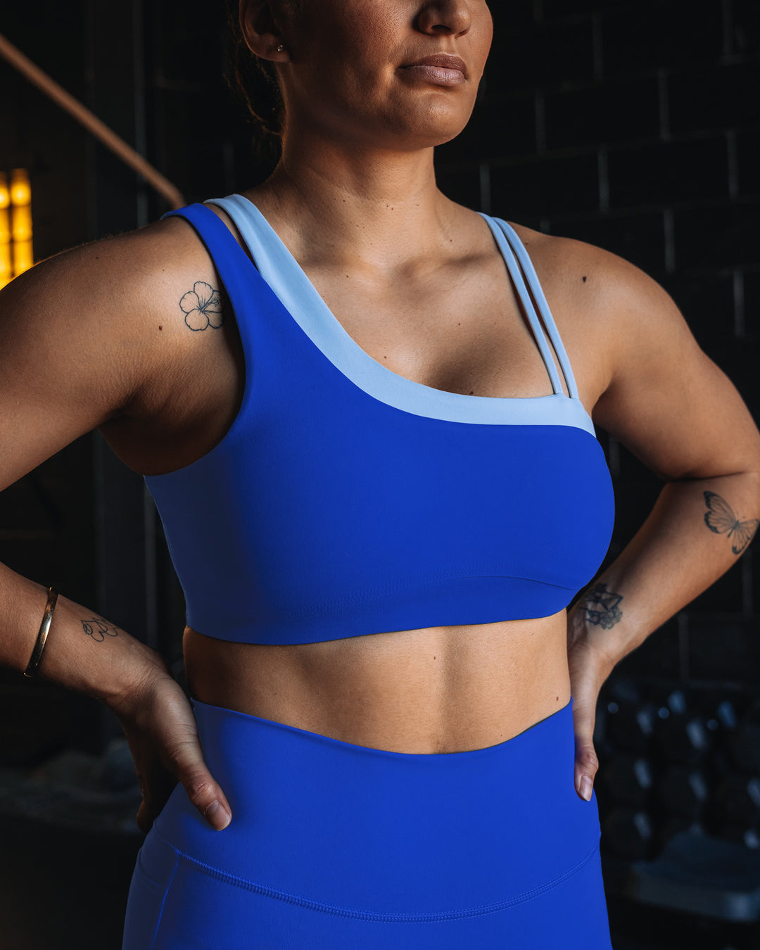 Woman wearing Thrive Asymmetric Sports Bra - Power Cobalt-Open Air | Model:Tiare | Size:M - view 9