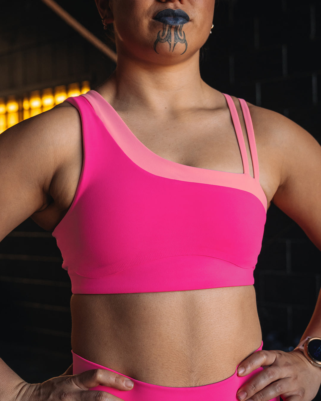 Woman wearing Thrive Asymmetric Sports Bra - Ultra Pink-Candy Pink | Model:Teraipine | Size:M - view 3