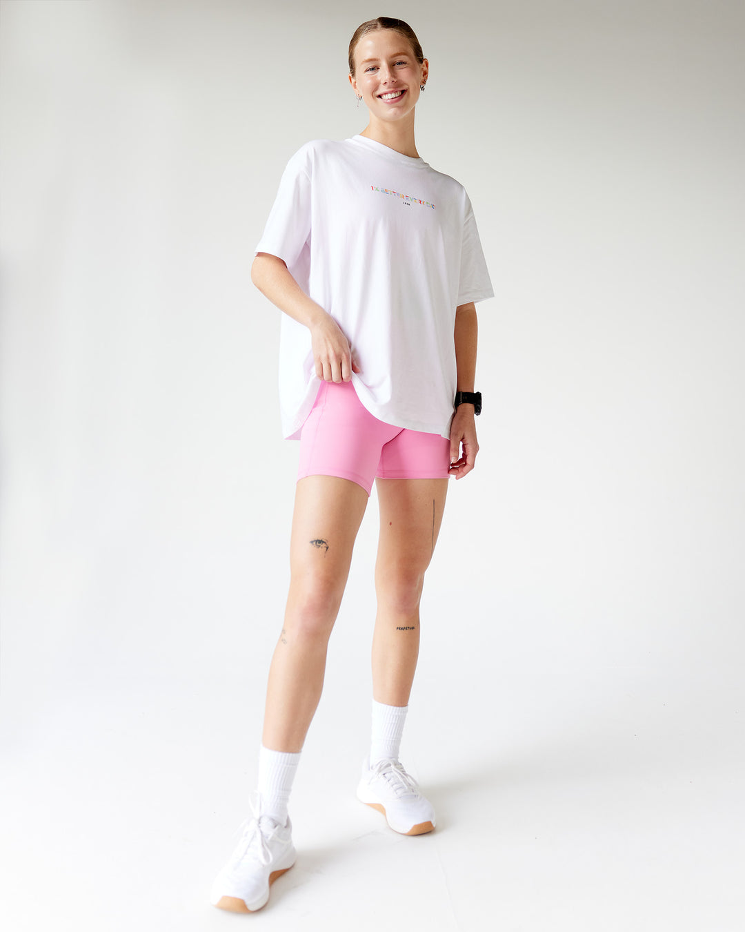 Woman wearing Unity Go-To FLX Cotton Tee - White-Rainbow | Model:Adi | Size:M - view 4