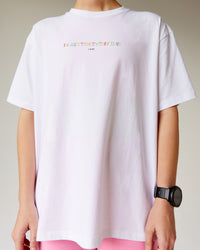 Woman wearing Unity Go-To FLX Cotton Tee - White-Rainbow | Model:Adi | Size:M | Thumbnail Index: 0