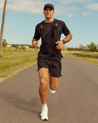 Woman wearing Pace Running Vest - Black-Reflective | Model:Jesse | Size:M/L | Thumbnail Index: 6
