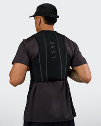 Woman wearing Pace Running Vest - Black-Reflective | Model:Daarian | Size:M/L | Thumbnail Index: 18