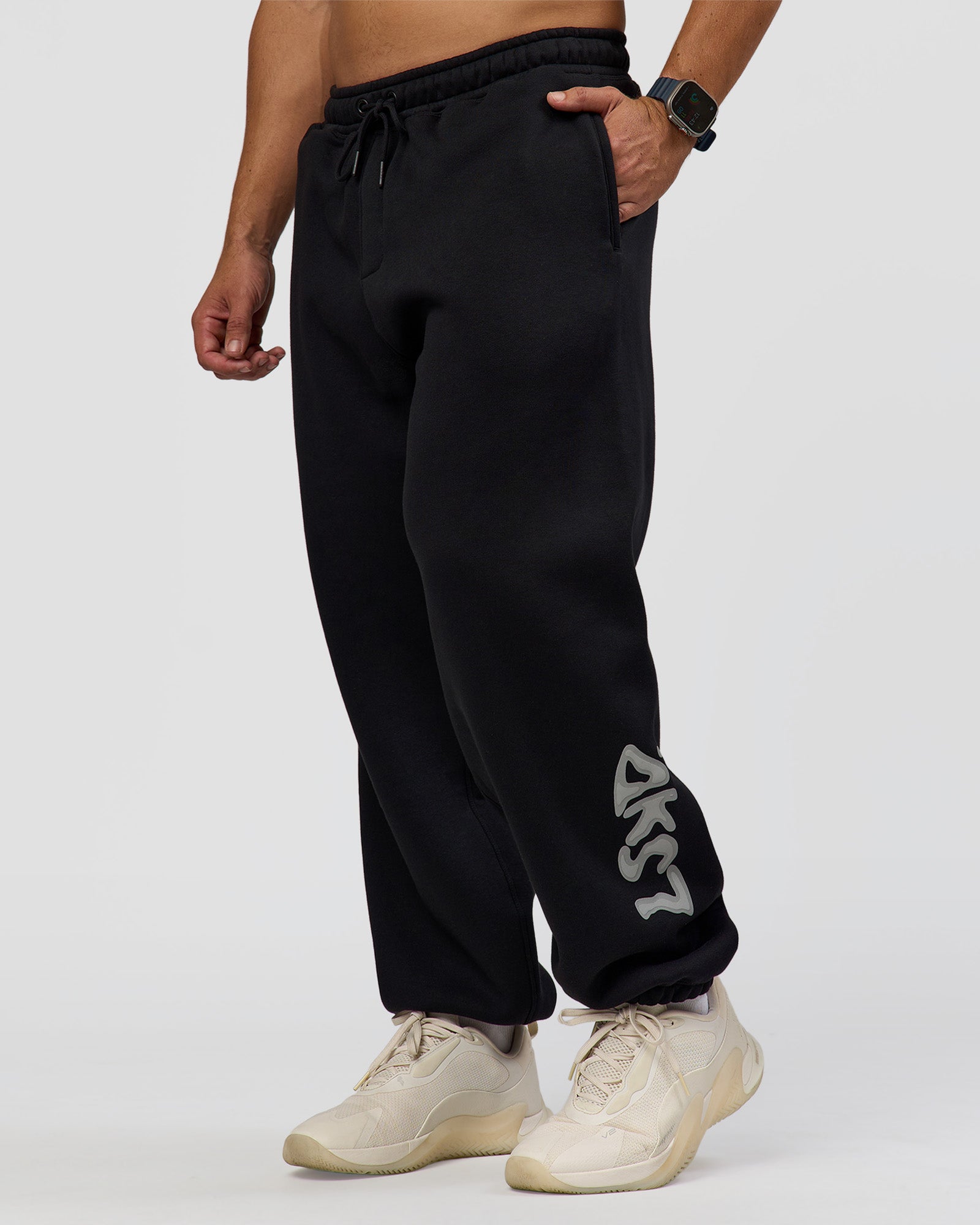 Man wearing Static Grit Baggy Track Pant - Black-Alloy | Model:Jaiden | Size:M