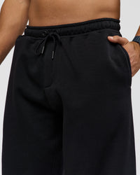 Man wearing Static Grit Baggy Track Pant - Black-Alloy | Model:Jaiden | Size:M | Thumbnail Index: 7