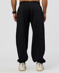 Man wearing Static Grit Baggy Track Pant - Black-Alloy | Model:Jaiden | Size:M | Thumbnail Index: 3