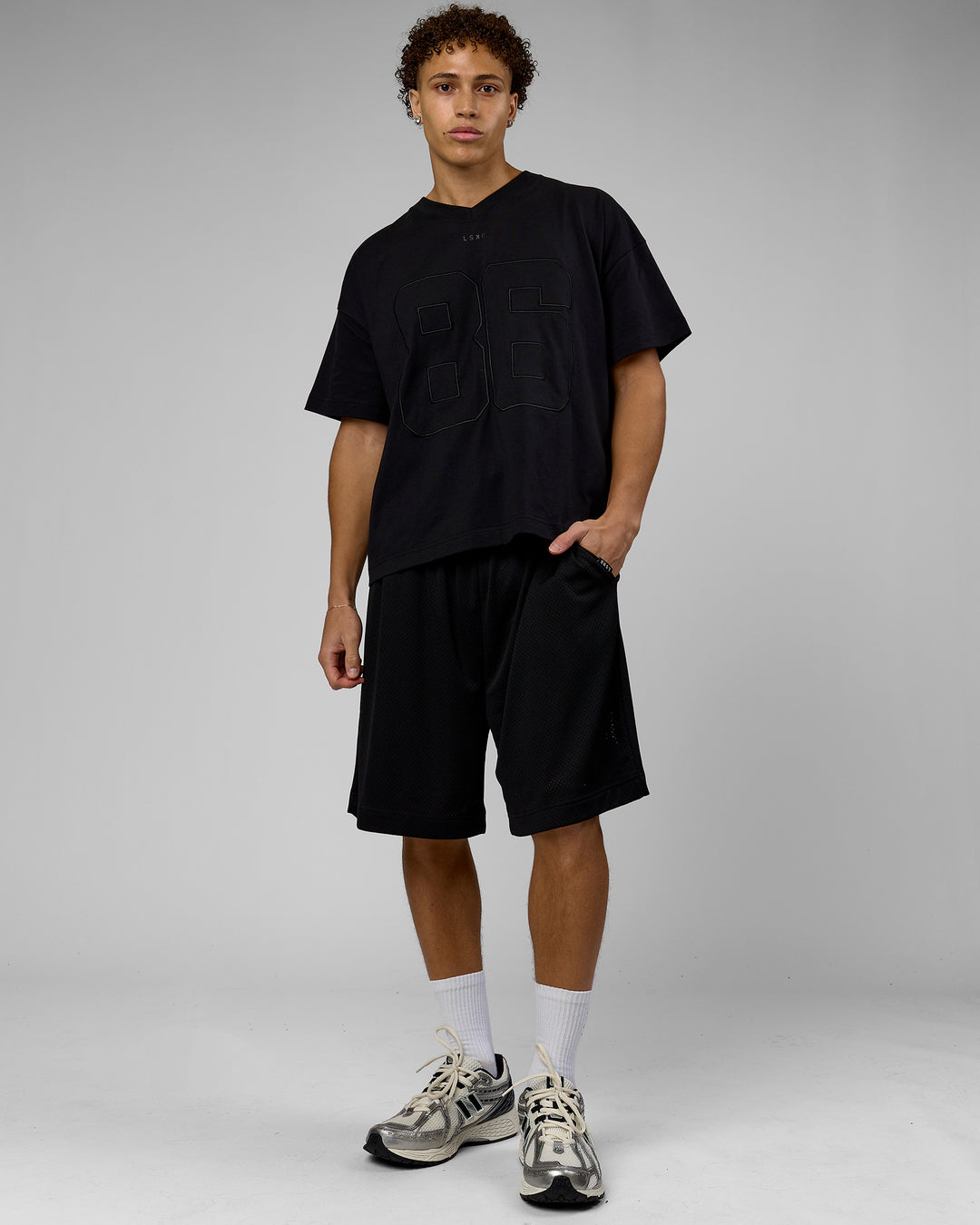Man wearing 86 V-Neck Oversized Tee - Black-Black | Model:Leandro | Size:M - view 6