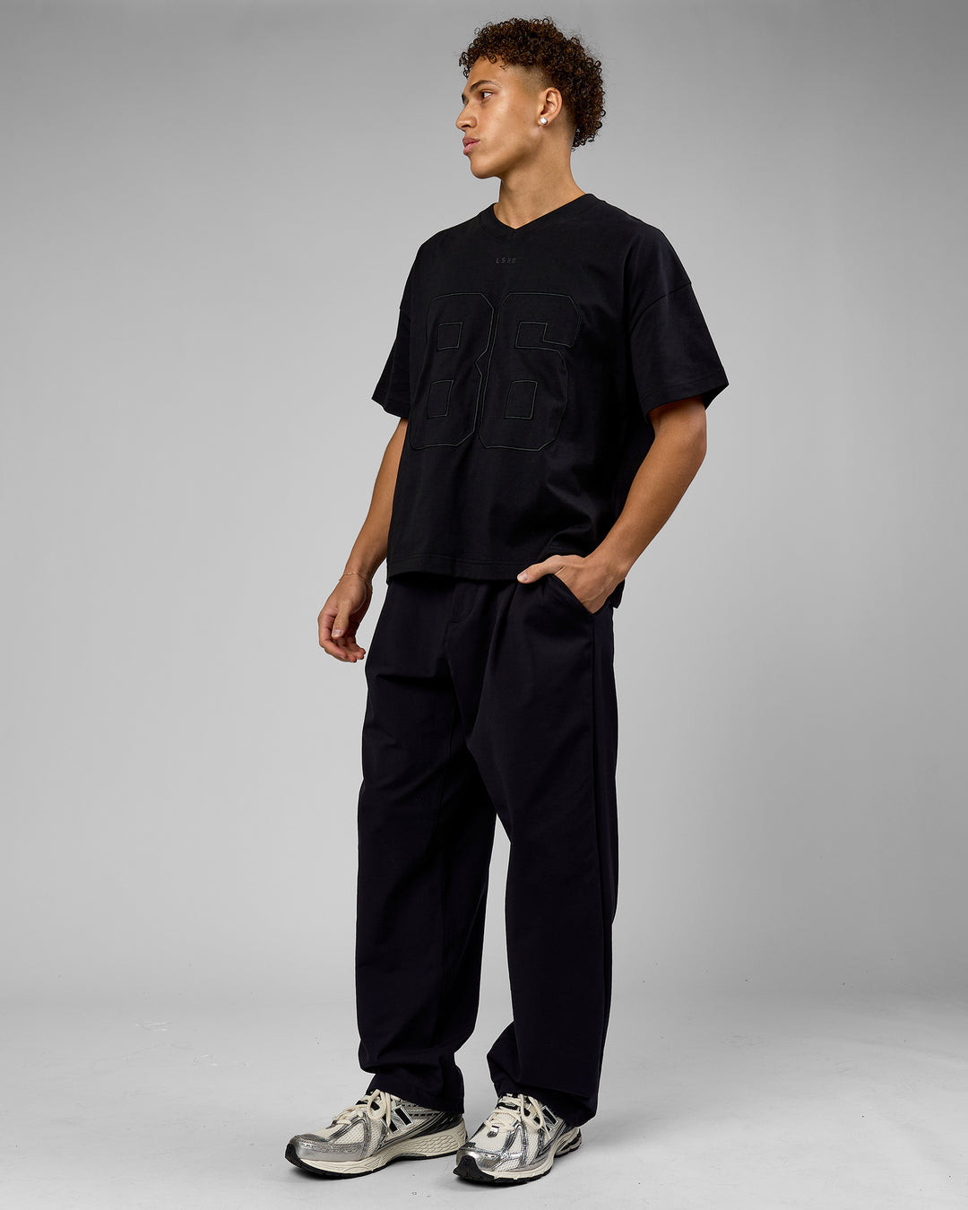 Man wearing 86 V-Neck Oversized Tee - Black-Black | Model:Leandro | Size:M - view 8