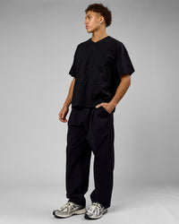 Man wearing 86 V-Neck Oversized Tee - Black-Black | Model:Leandro | Size:M | Thumbnail Index: 7