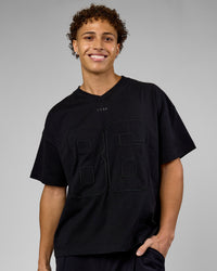 Man wearing 86 V-Neck Oversized Tee - Black-Black | Model:Leandro | Size:M | Thumbnail Index: 0