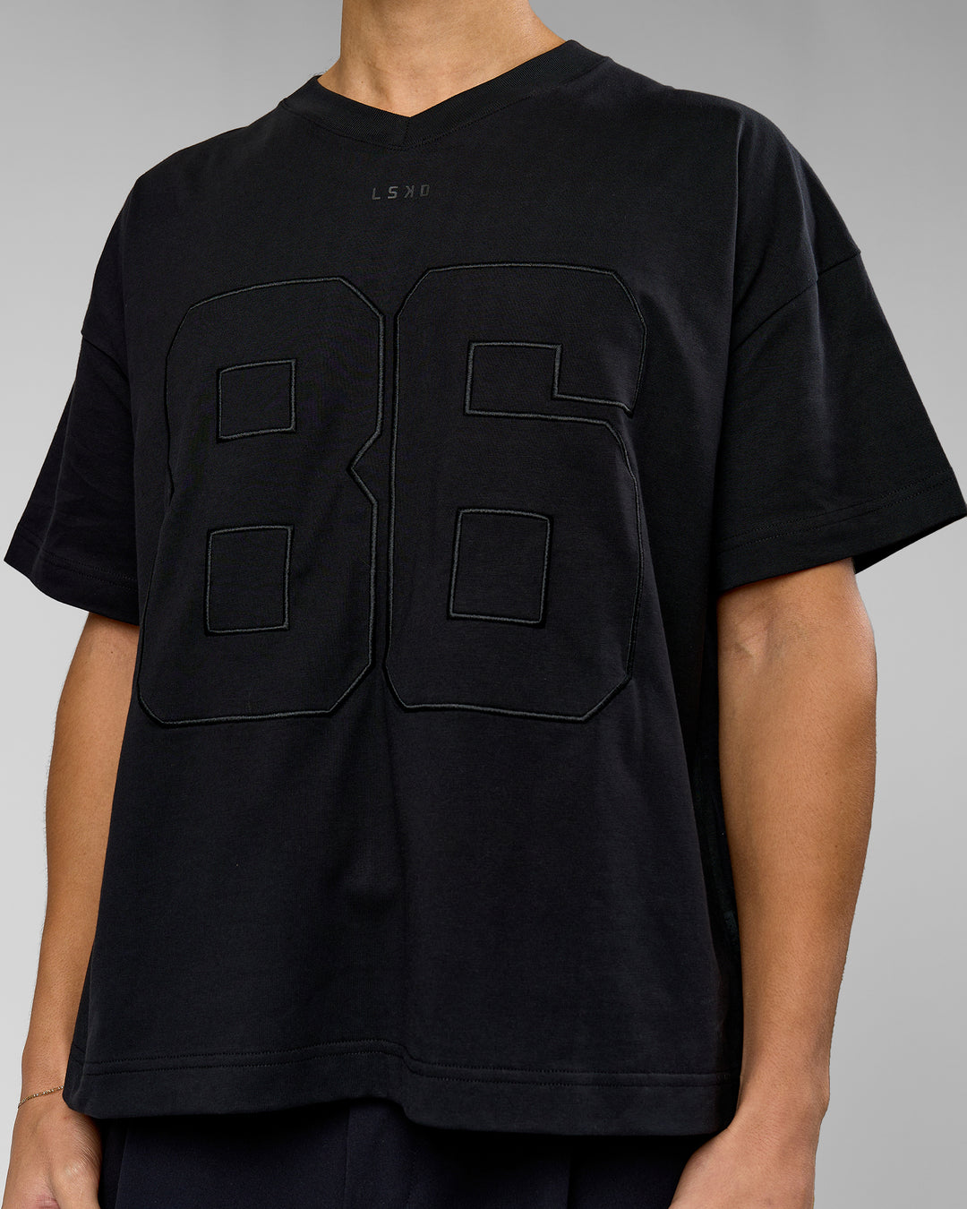 Man wearing 86 V-Neck Oversized Tee - Black-Black | Model:Leandro | Size:M - view 7