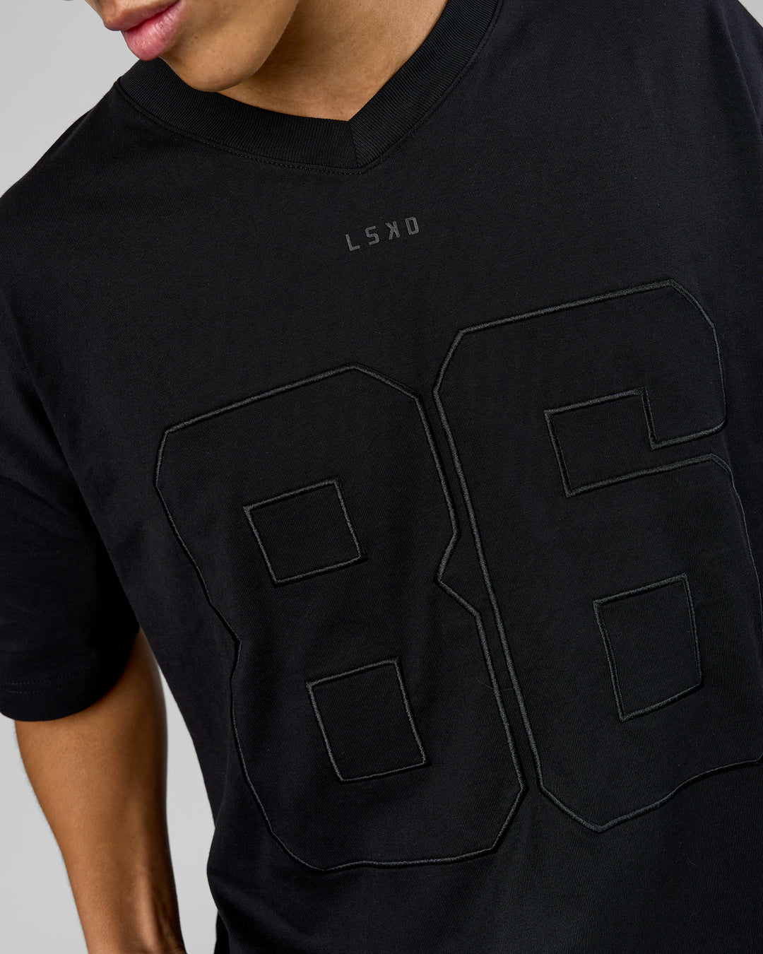 Man wearing 86 V-Neck Oversized Tee - Black-Black | Model:Leandro | Size:M - view 3