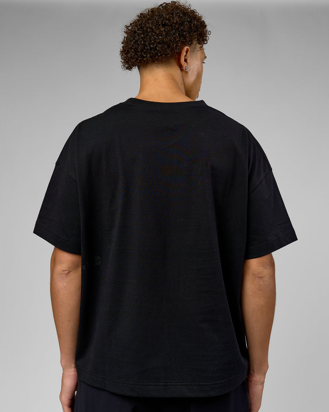 Man wearing 86 V-Neck Oversized Tee - Black-Black | Model:Leandro | Size:M - view 4