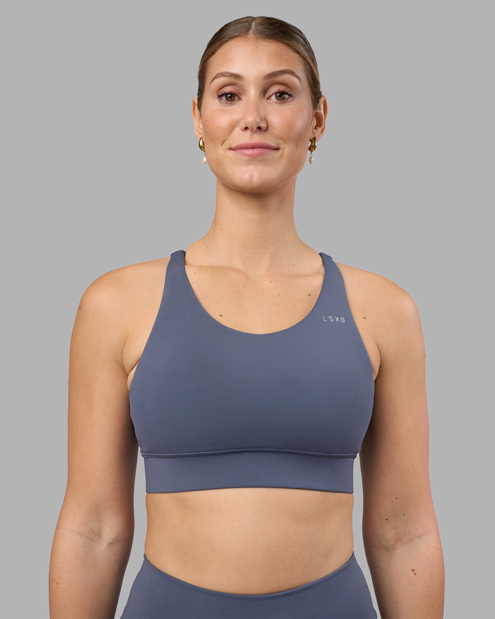 Woman wearing Accelerate Sports Bra - Night Shadow | Set:true | Angle:front | Model:Amy | Size:M