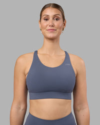Woman wearing Accelerate Sports Bra - Night Shadow | Set:true | Angle:front | Model:Amy | Size:M | Thumbnail Index: 0