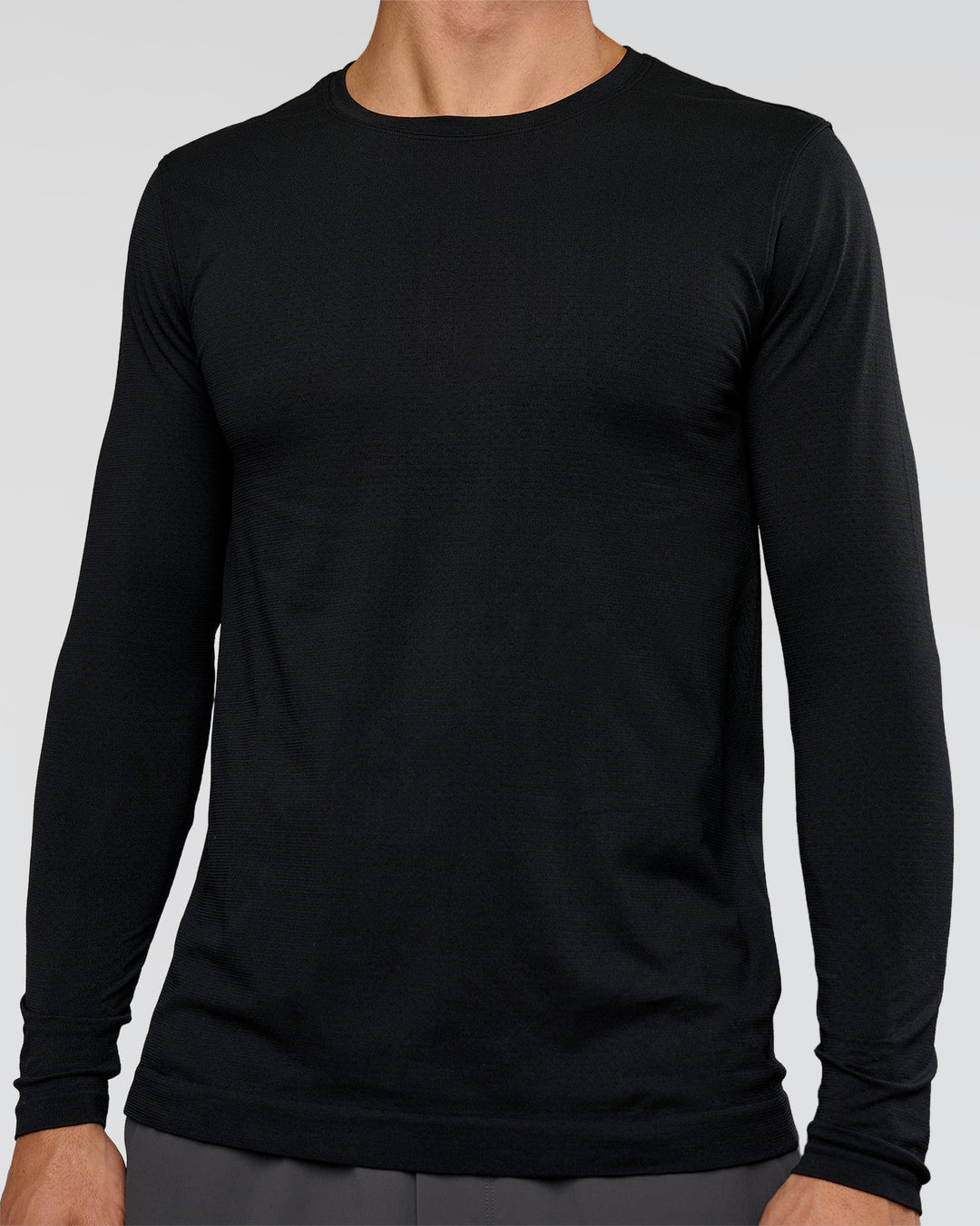Man wearing AeroFLX+ Seamless Long Sleeve Tee (Set in Sleeve) in Black/Black | Model:Albert | Size:M - view 2