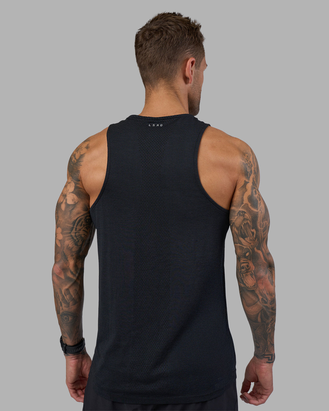 Man wearing AeroFLX+ Seamless Tank - Black Marl | Model:Tommy | Size:M - view 3
