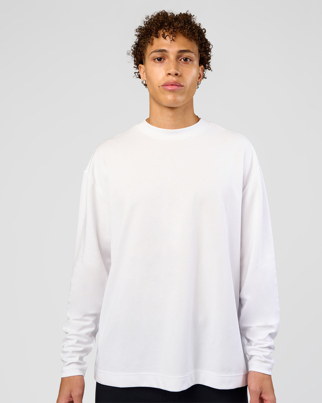 Man wearing AfterDark ZeroCrease Long Sleeve Tee - White | Model:Leandro | Size:M - view 12