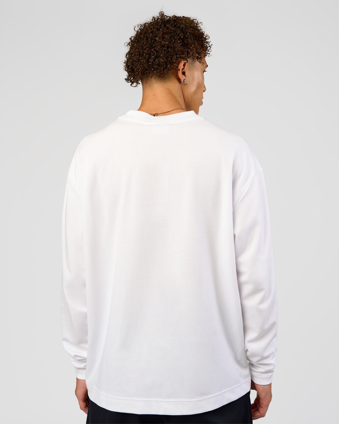 Man wearing AfterDark ZeroCrease Long Sleeve Tee - White | Model:Leandro | Size:M - view 6