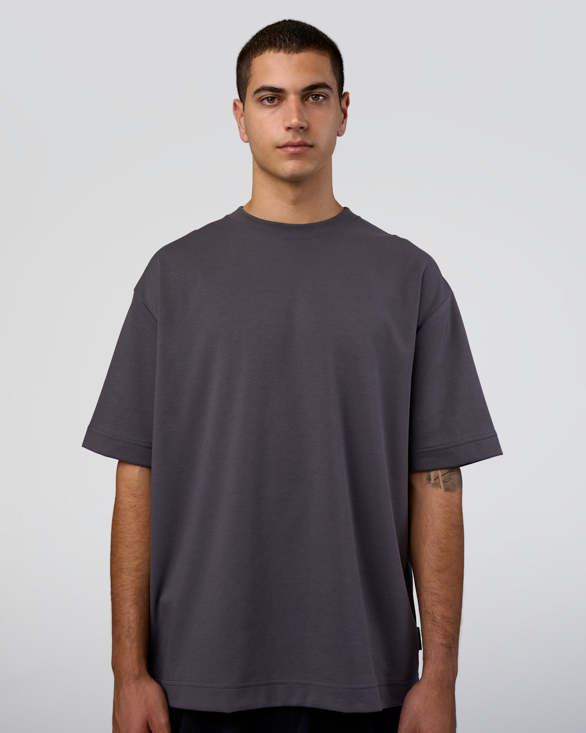 Man wearing AfterDark ZeroCrease Oversized Tee - Dark Storm | Model:Zoran | Size:M