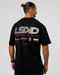 Man wearing Archive FLXCotton Oversized Tee - Black-Scarlet | Model:Jaiden | Size:M | Thumbnail Index: 1