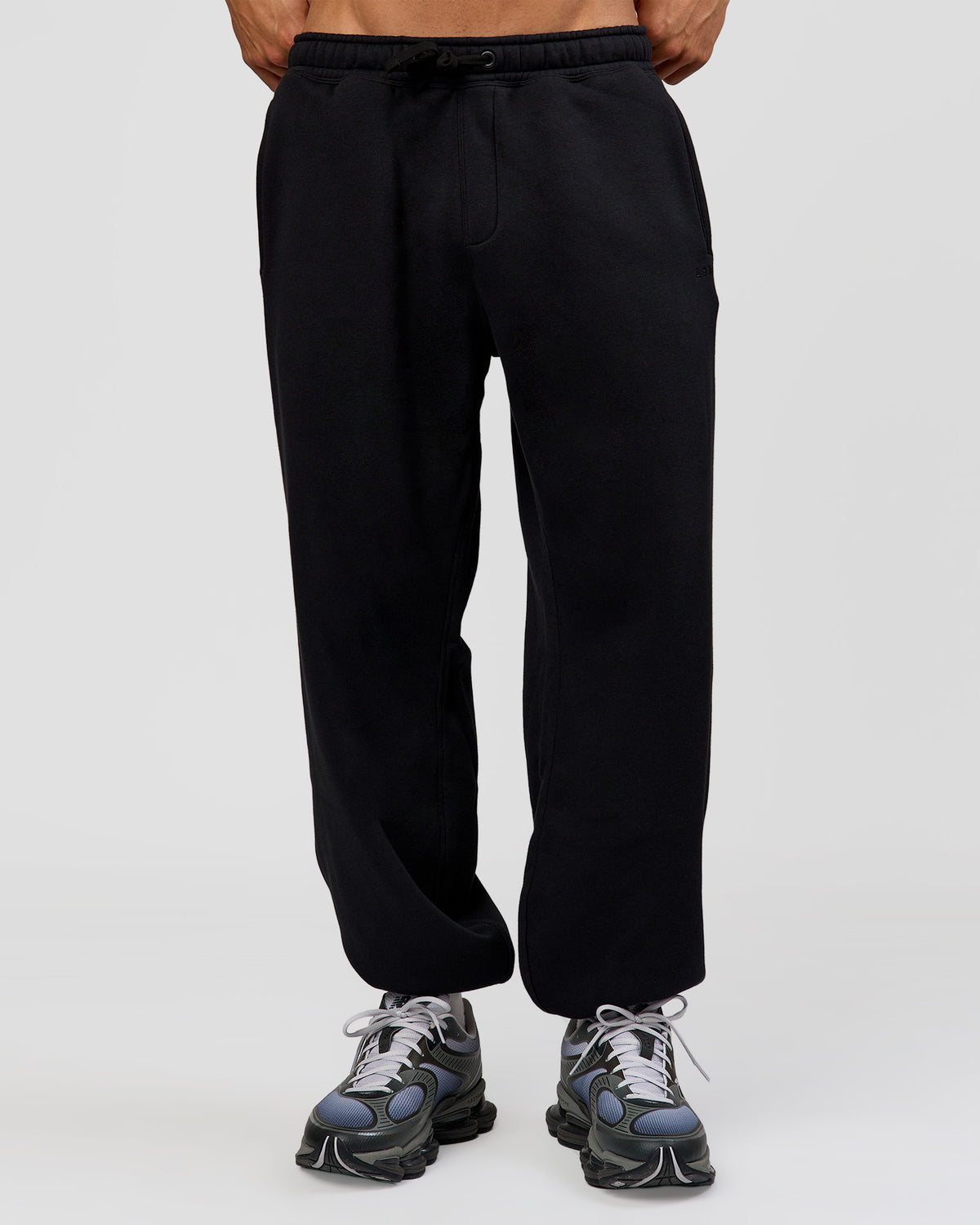 Man wearing Base Baggy Cuffed Track Pant - Black | Model:Albert | Size:M |
