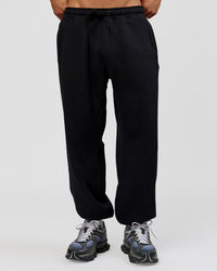 Man wearing Base Baggy Cuffed Track Pant - Black | Model:Albert | Size:M |
 | Thumbnail Index: 0