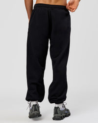 Man wearing Base Baggy Cuffed Track Pant - Black | Model:Albert | Size:M | | Thumbnail Index: 2
