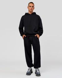 Man wearing Base Baggy Cuffed Track Pant - Black | Model:Albert | Size:M | | Thumbnail Index: 1