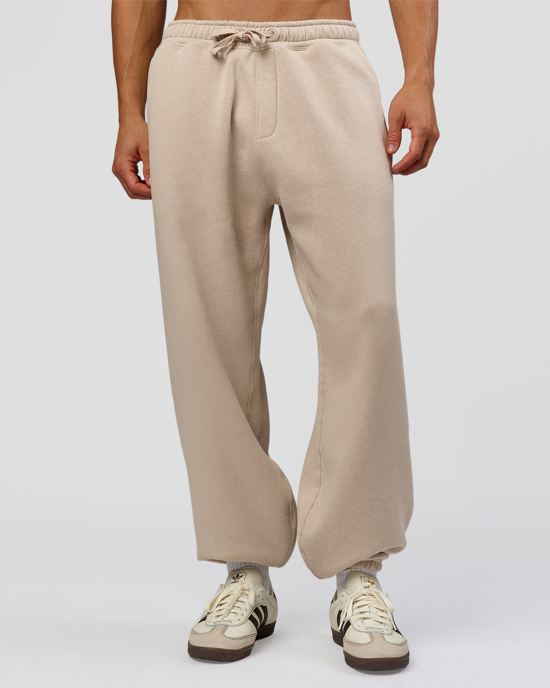 Man wearing Base Baggy Cuffed Track Pant - Shale Beige | Model:Albert | Size:M | - view 1