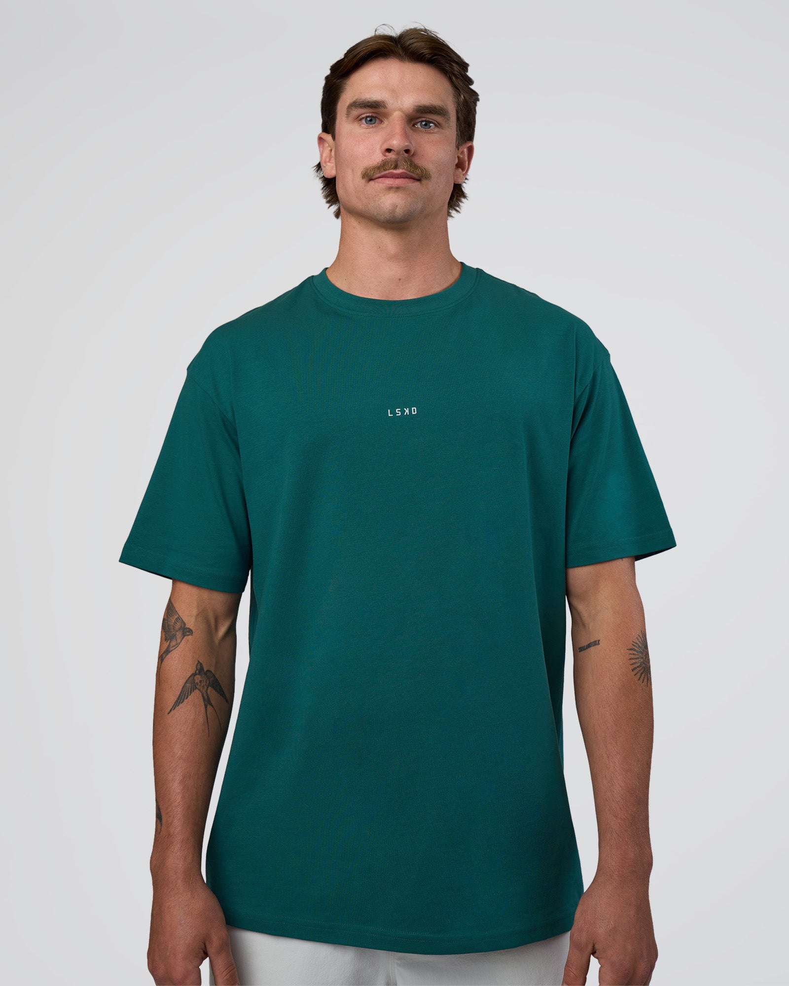 Man wearing Base FLXCotton Tee Oversized - Transformative Teal | Model:Konnor | Size:M