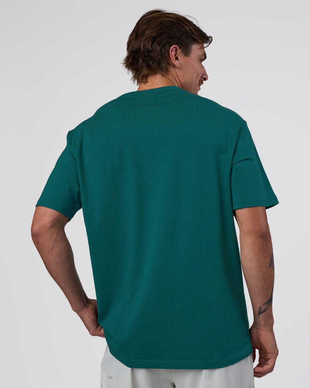 Man wearing Base FLXCotton Tee Oversized - Transformative Teal | Model:Konnor | Size:M - view 3