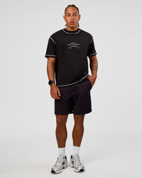 Man wearing CF Unisex Oversized Heavyweight FLXCotton Tee - Black-CF Move Through It | Model:Malebo | Size:M | Thumbnail Index: 3