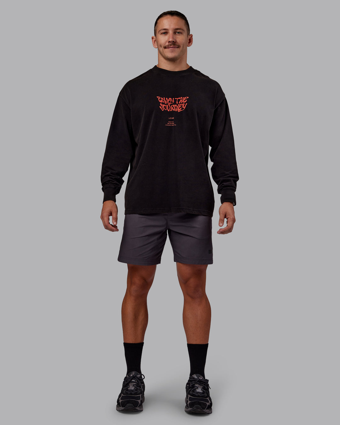 Man wearing Chrome Washed Heavyweight Oversized Long Sleeve Tee - Black-Ultra Orange | Model:Jaiden | Size:M - view 1